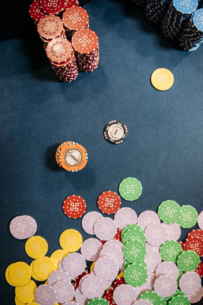 about-img Colorful casino chips scattered and stacked on a gaming table, capturing the essence of gambling excitement.
